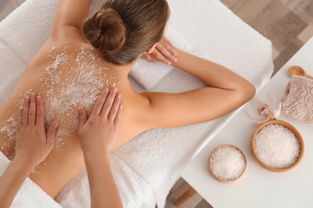 woman getting body scrub